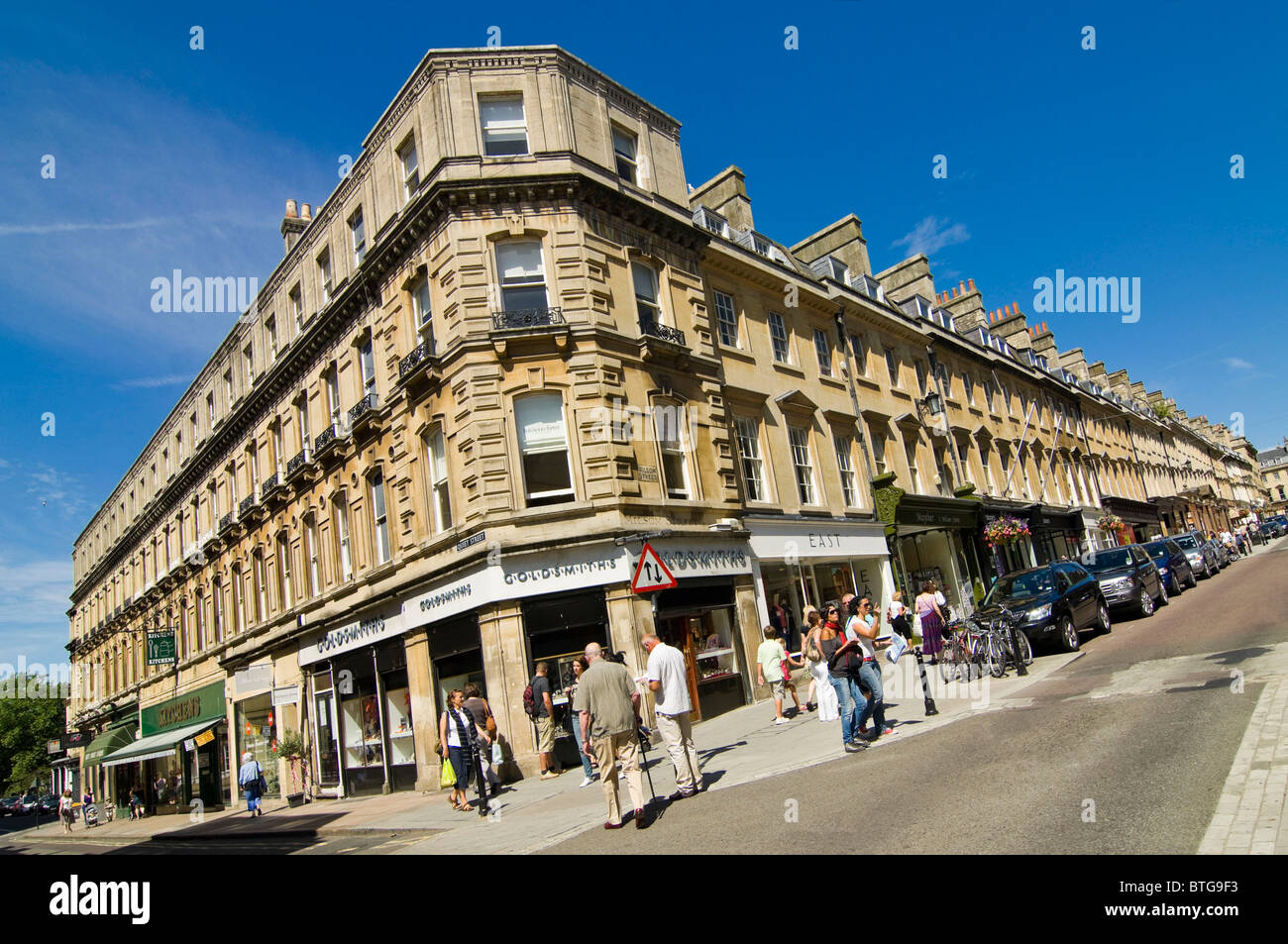 Horizontal wide angle view of classic Bathstone architecture in Bath city centre on a bright summer day. Stock Photo