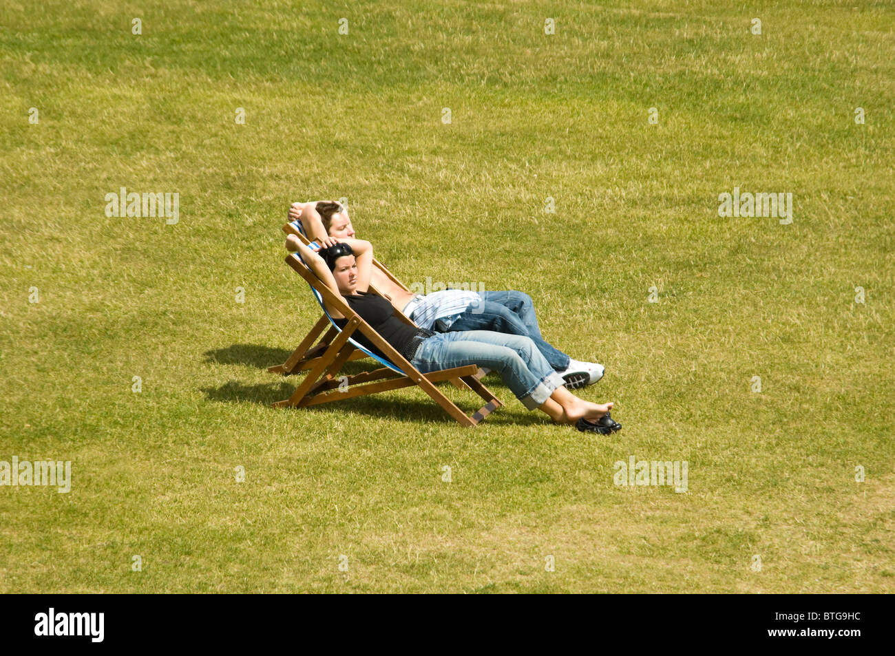 Seated man reclining woman hi-res stock photography and images - Alamy