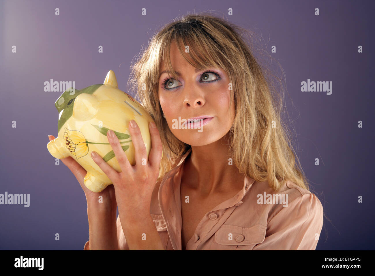 Woman holding a piggy bank Stock Photo - Alamy