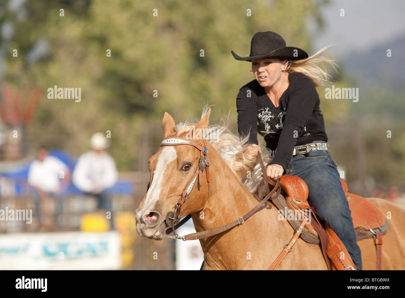 Cowgirl Chris Azevedo competes in the Barrel Race event at the San Dimas Rodeo in San Dimas on October 2, 2010. Stock Photo