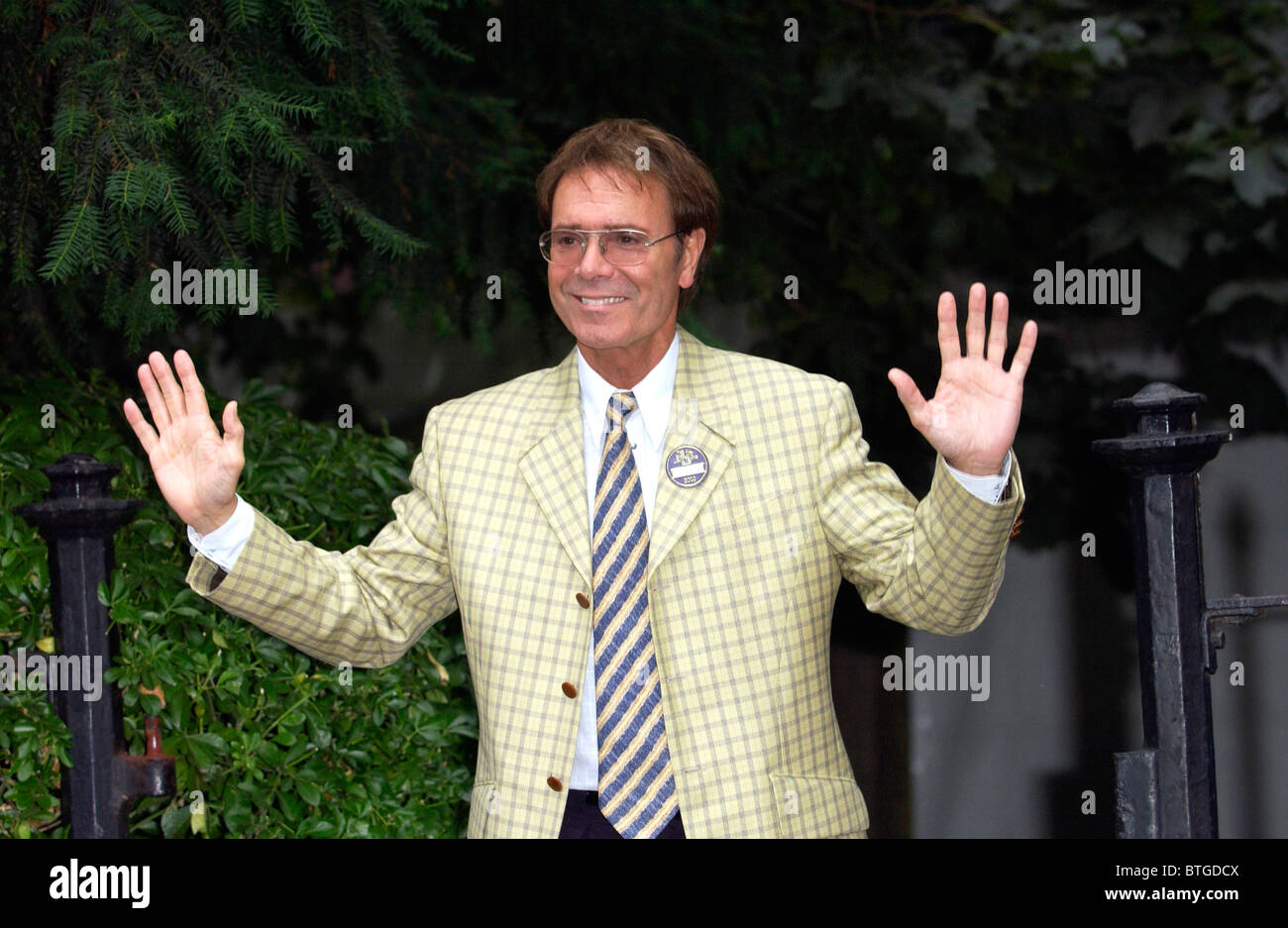 Musician and singer Sir Cliff Richard wearing a yellow checked jacket, at a party in Carlyle Square in Chelsea, London Stock Photo