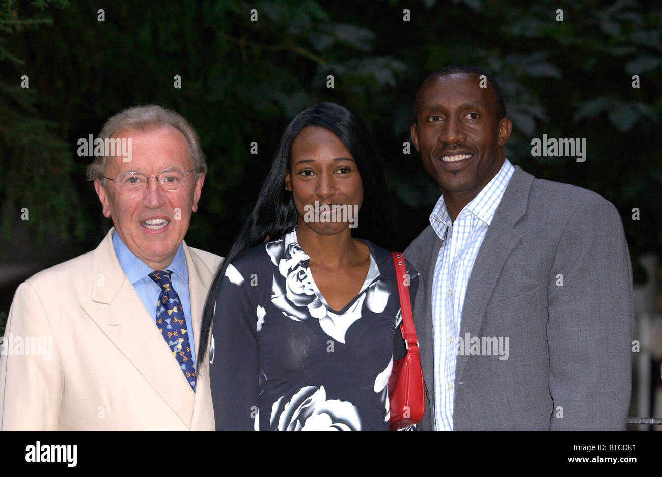 Party host Sir David Frost with his guest Linford Christie who joins other celebrities for a party in Carlyle Square, Chelsea Stock Photo
