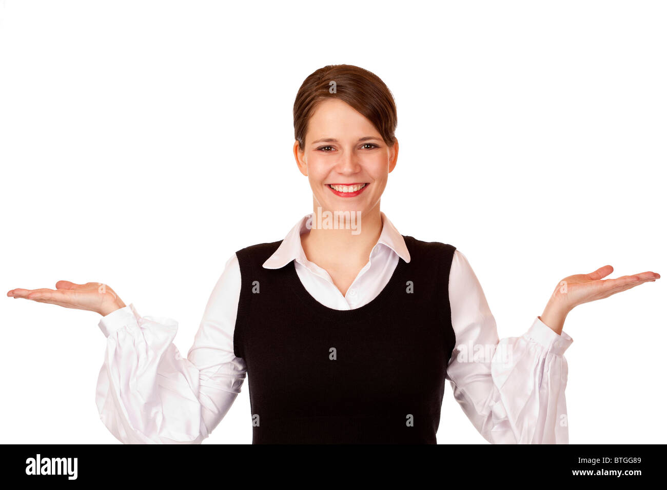 Young happy businesswoman holds both hands for advertisement.  Isolated on white background. Stock Photo