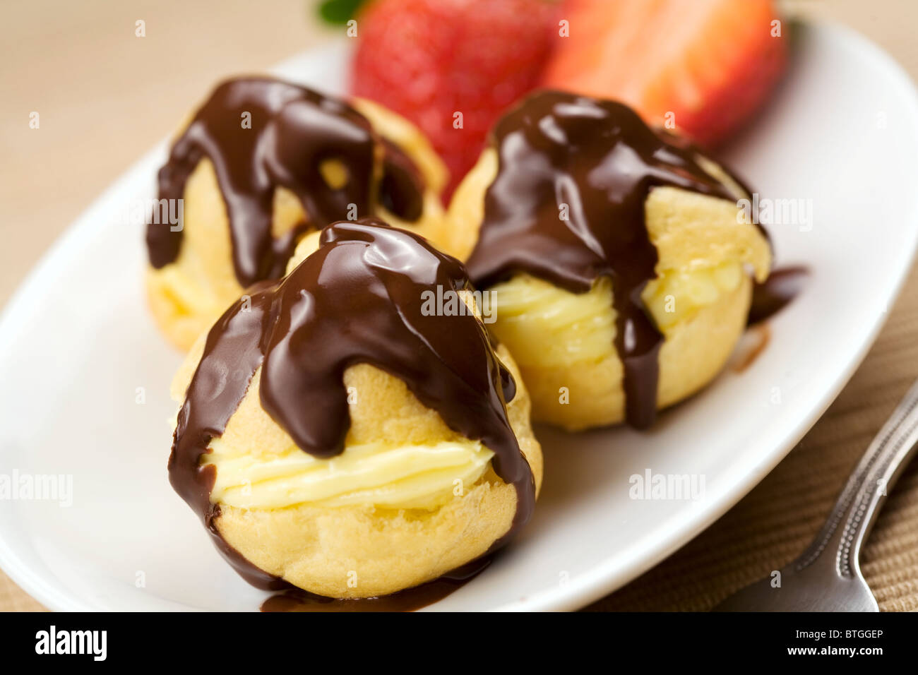 profiterole covered in chocolate sauce Stock Photo