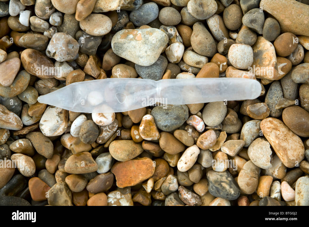 Plastic marine pollution shingle beach washed up Stock Photo
