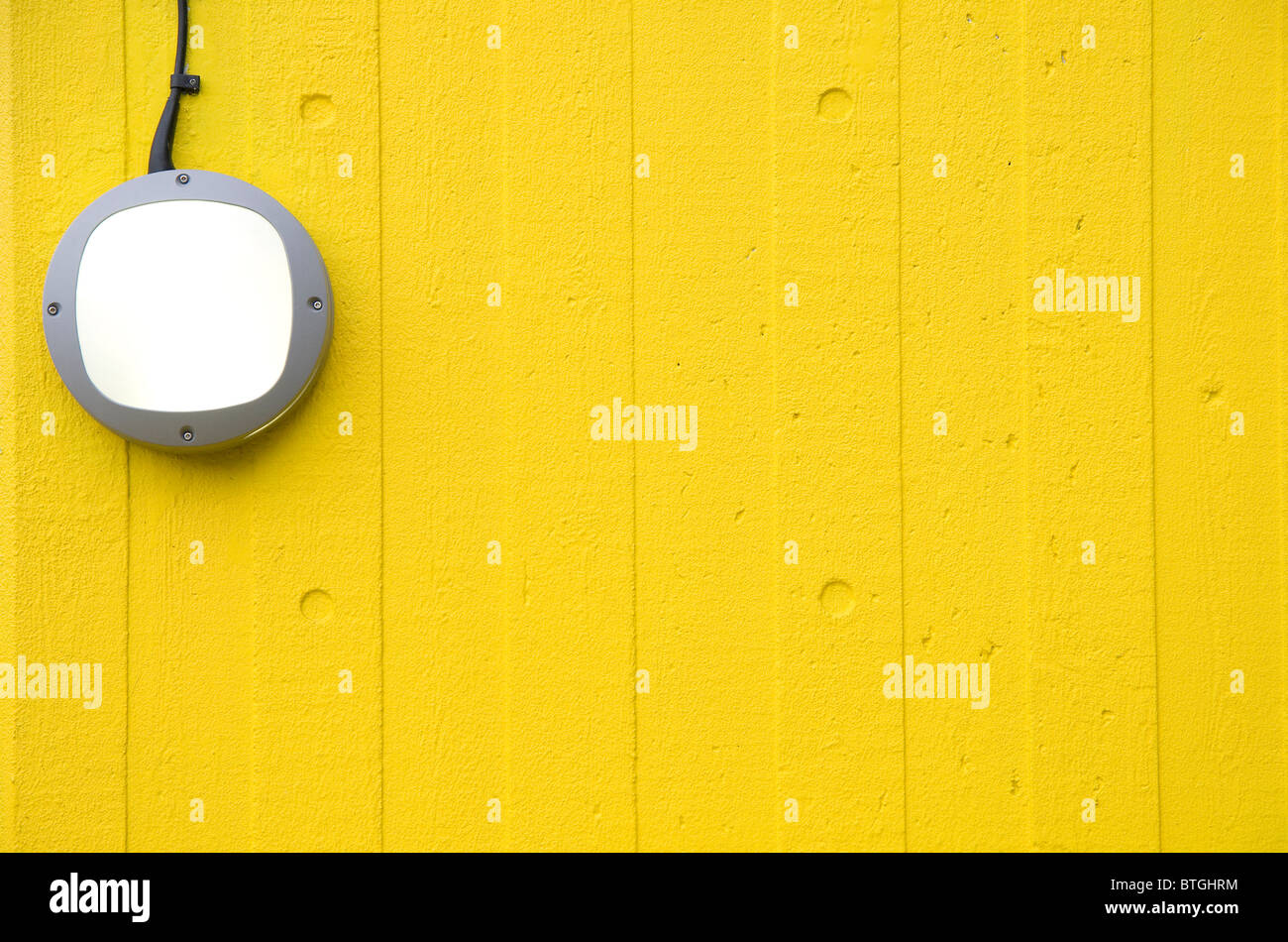 outside wall light on yellow wall Stock Photo Alamy