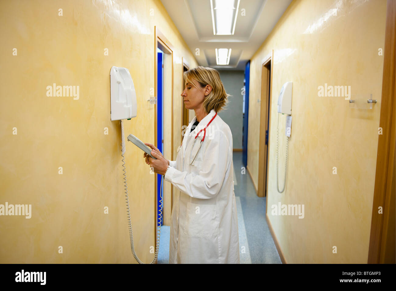 Doctor making telephone call in medical center Stock Photo