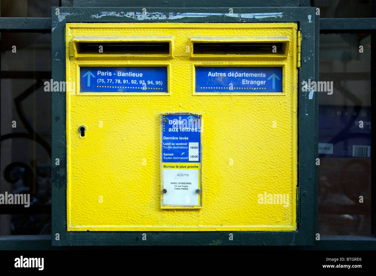 cheerful bright yellow vintage Parisian postal collection box mounted ...