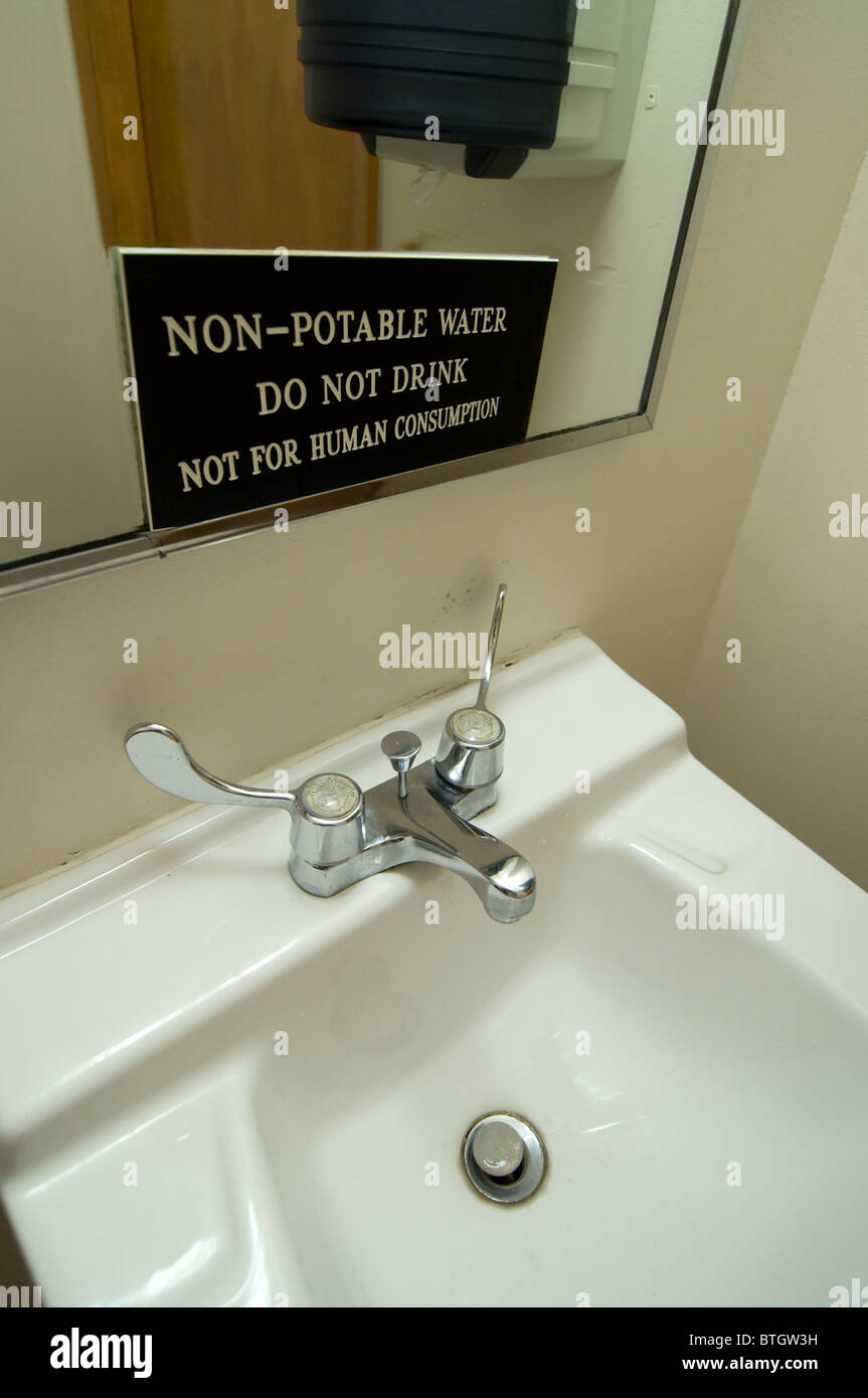 non potable water sign over bathroom sink Stock Photo