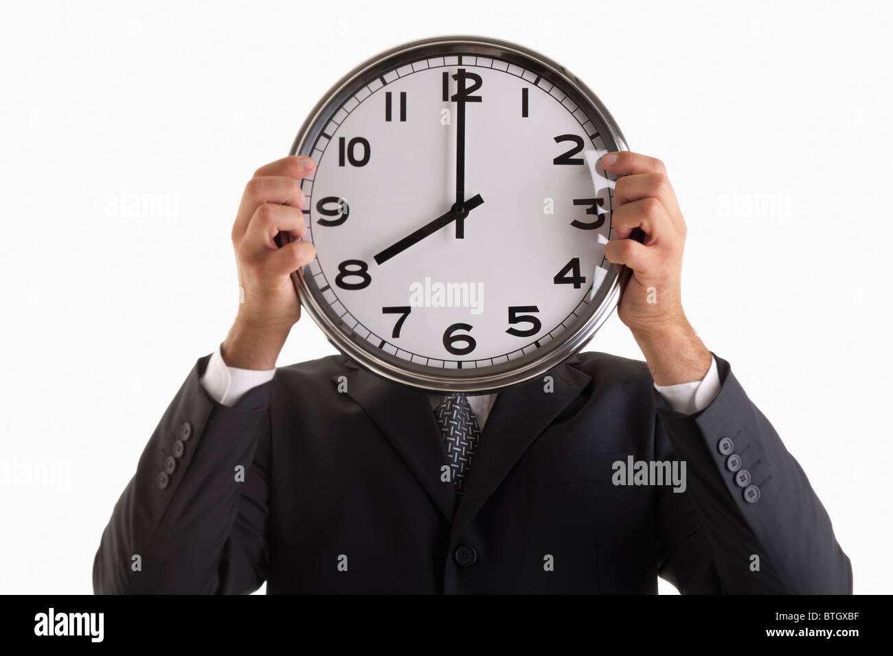 Man holding clock in front of his face Stock Photo Alamy