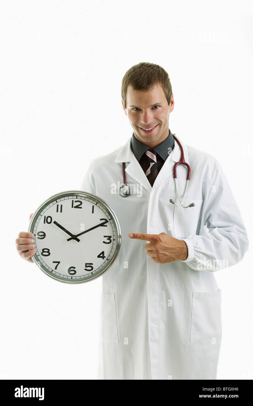 Doctor holding clock showing time Stock Photo Alamy