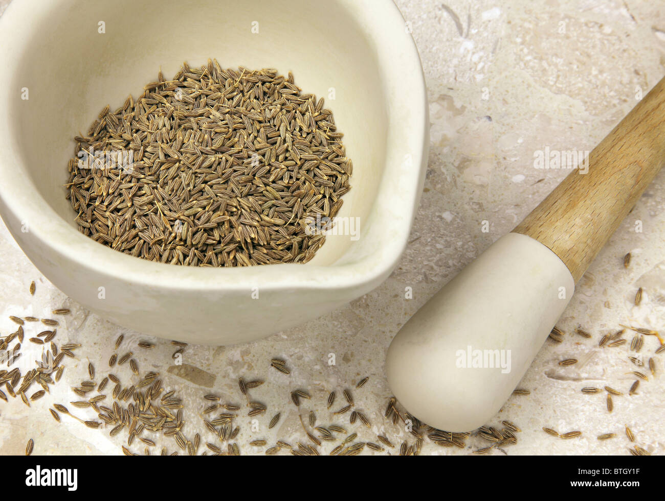 Cumin seeds in pestle and mortar Stock Photo