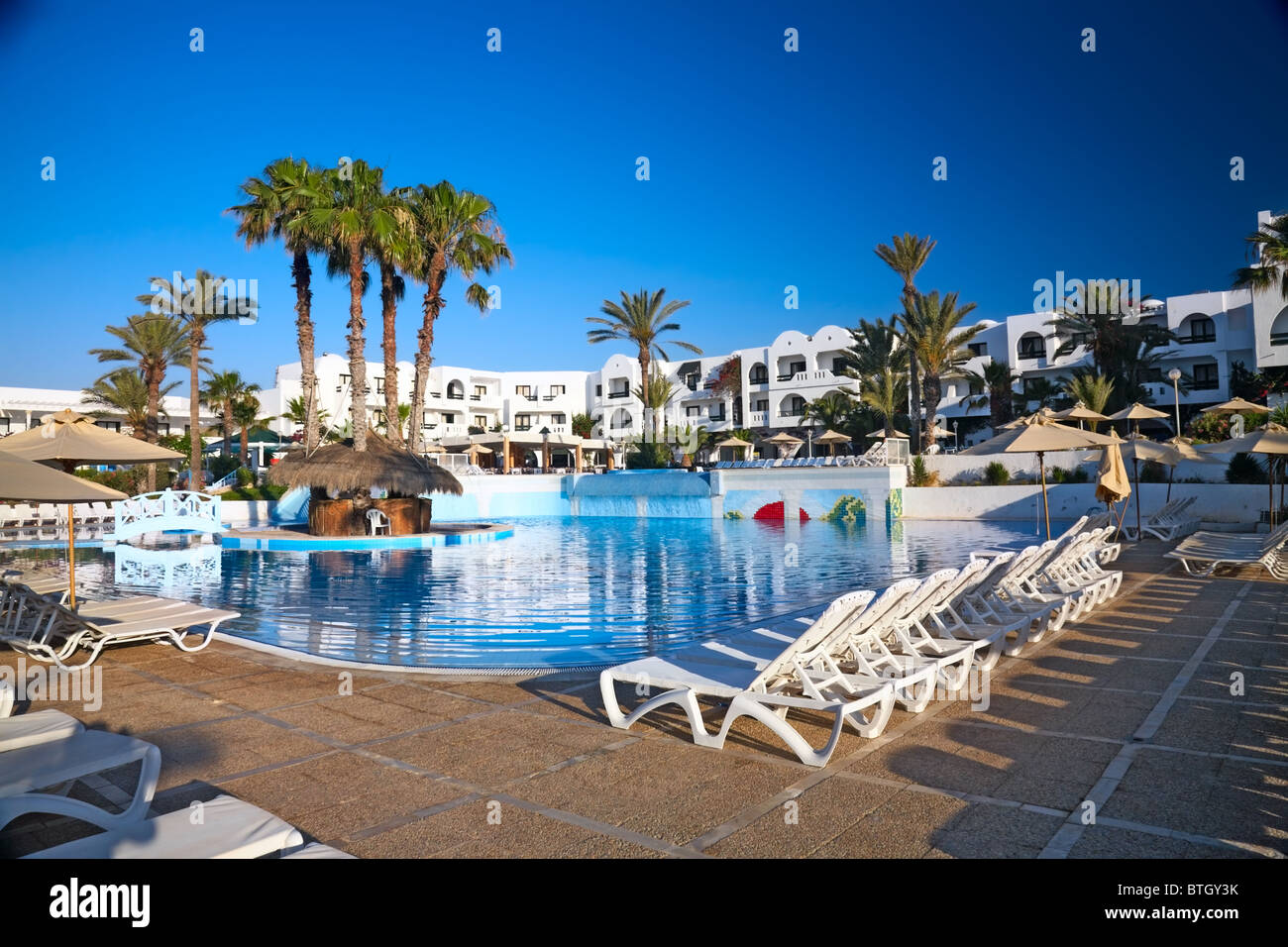 swimming pool with palm trees, Djerba, Tunisia Stock Photo