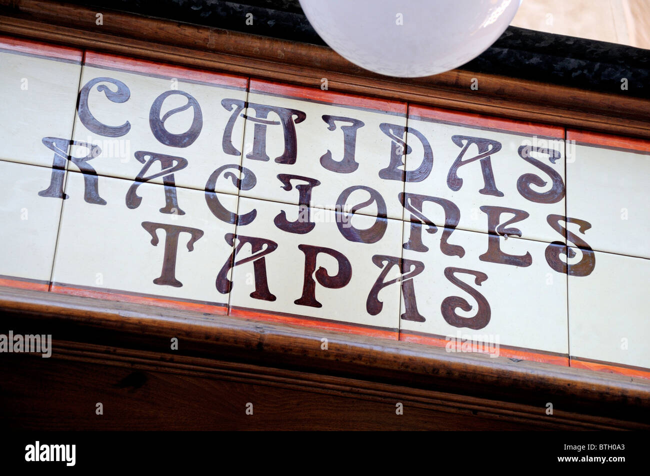 Madrid, Spain. Tiled sign above restaurant door - 'Comidas, Raciones, Tapas' Stock Photo