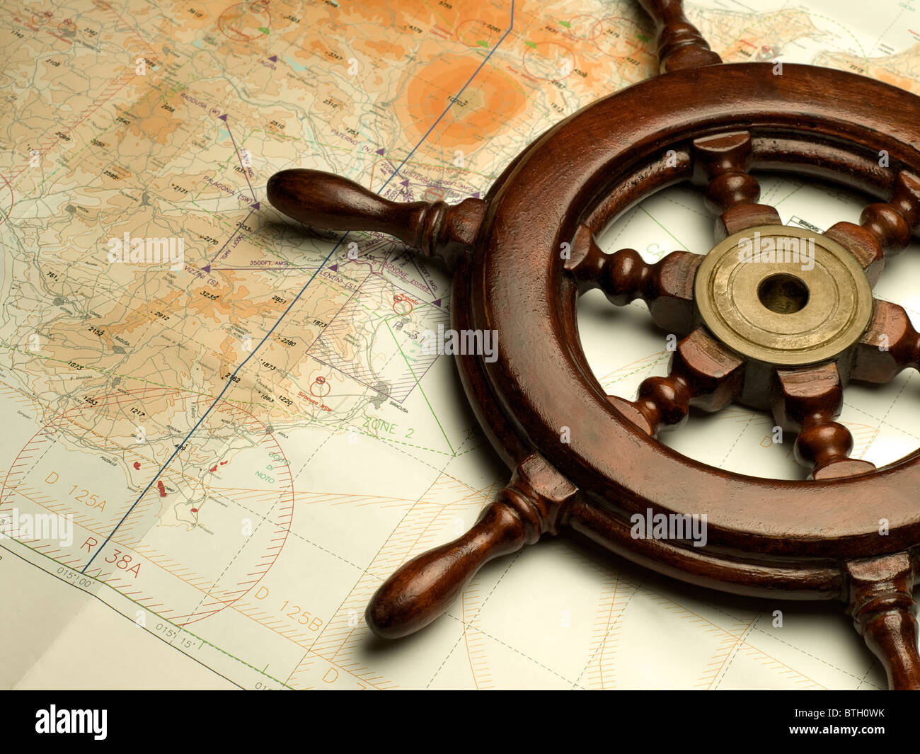 helm and nautical map, useful for various navigation or travel themes Stock Photo