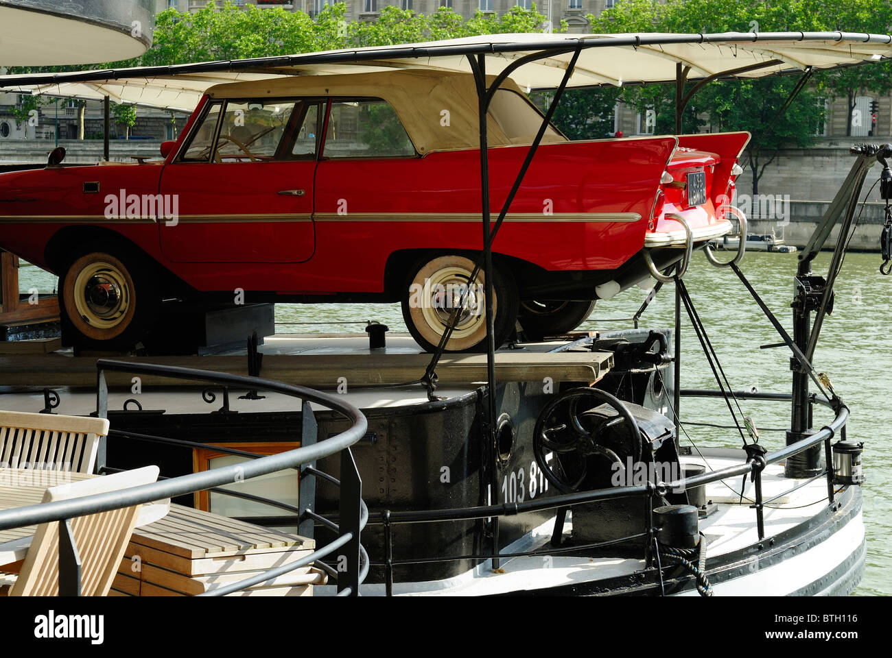 Red car parked on barge on quay in paris hires stock photography and