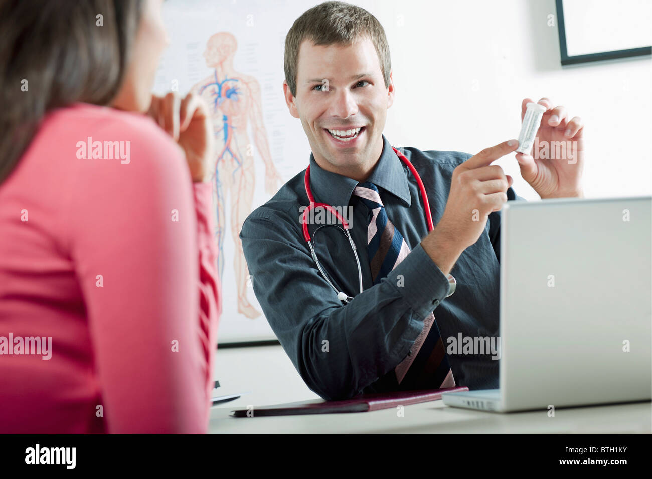 Doctor holding bottle of pills for patient Stock Photo
