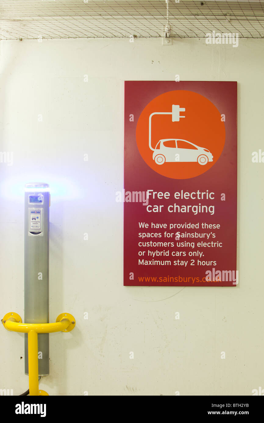An electric vehicle charging station provided free of charge for customers at Camden Sainsbury's supermarket in London, UK. Stock Photo