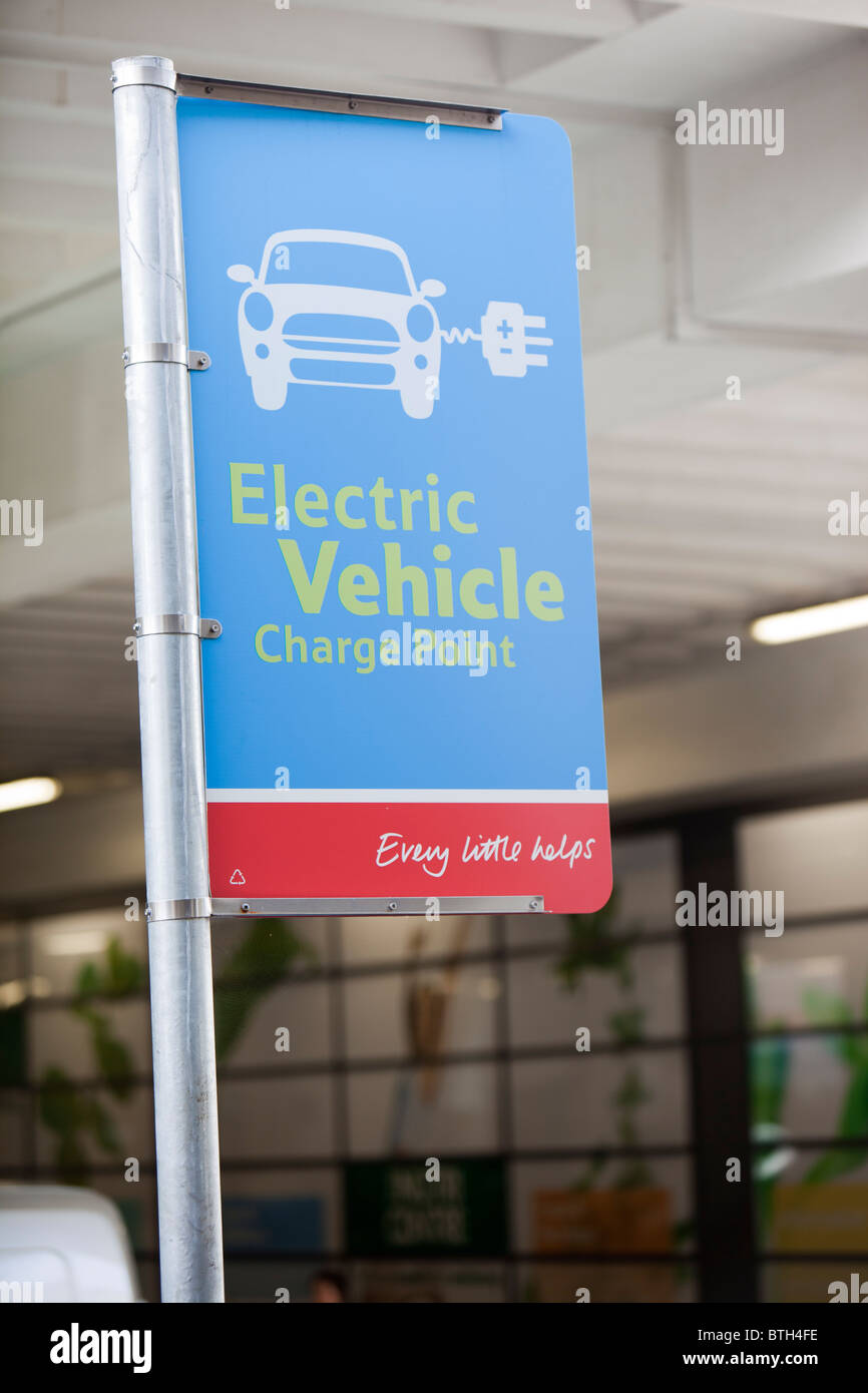 An electric car charging point provided free of charge in a Tesco Supermarket car park for their customers, London. Stock Photo