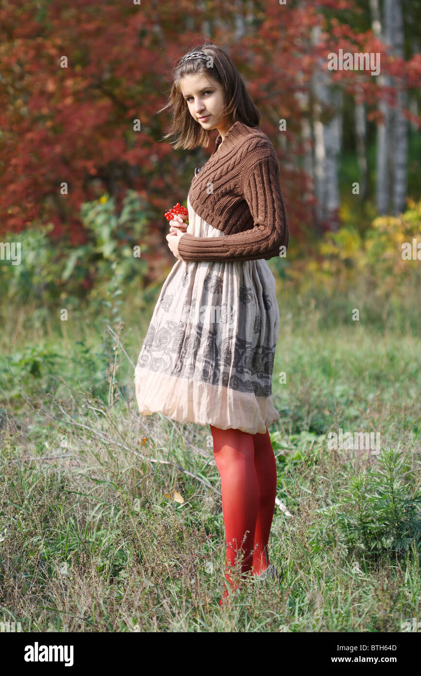 Portrait of pretty young girl in autumn forest Stock Photo - Alamy