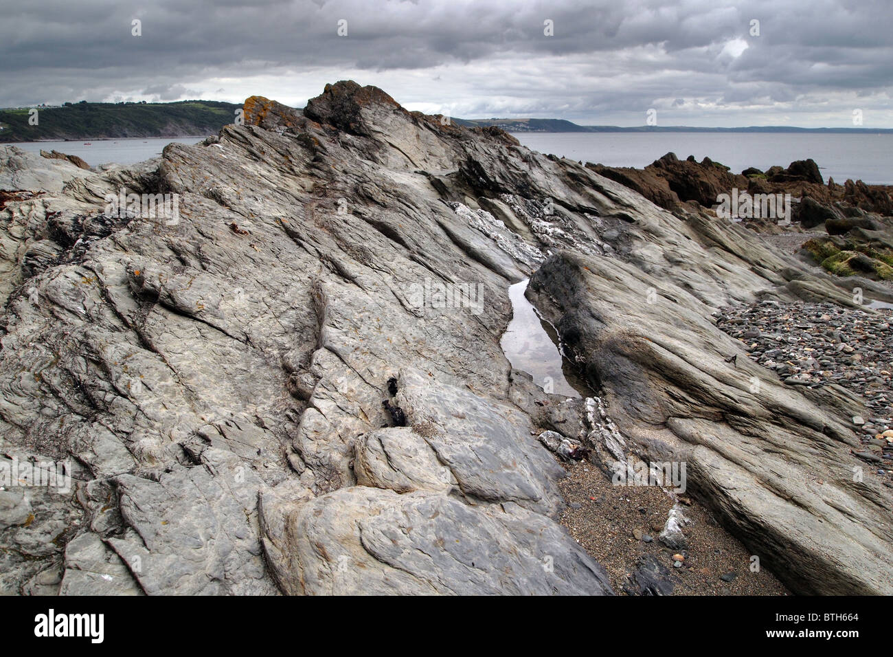 dramatic jagged rock strata formations on a beach in Cornwall England