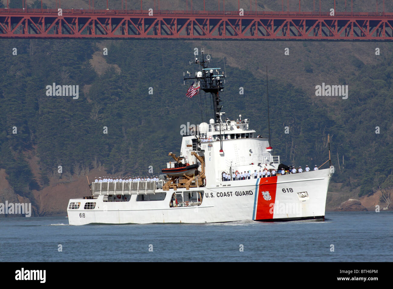 The United States Coast Guard Cutter Active (WMEC-618) travels across San Francisco Bay past the Golden Gate Bridge Stock Photo