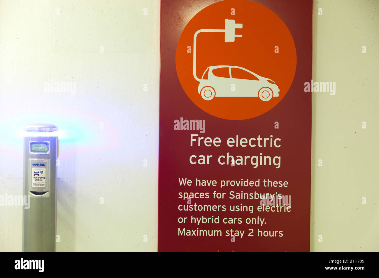 An electric vehicle charging station provided free of charge for customers at Camden Sainsbury's supermarket in London, UK. Stock Photo