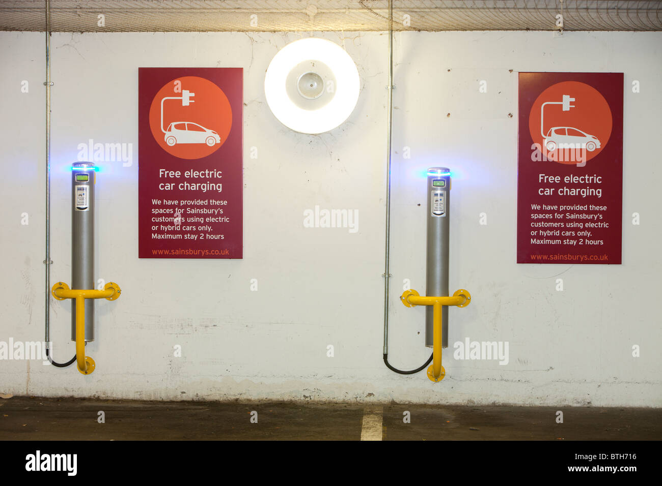 An electric vehicle charging station provided free of charge for customers at Camden Sainsbury's supermarket in London, UK. Stock Photo