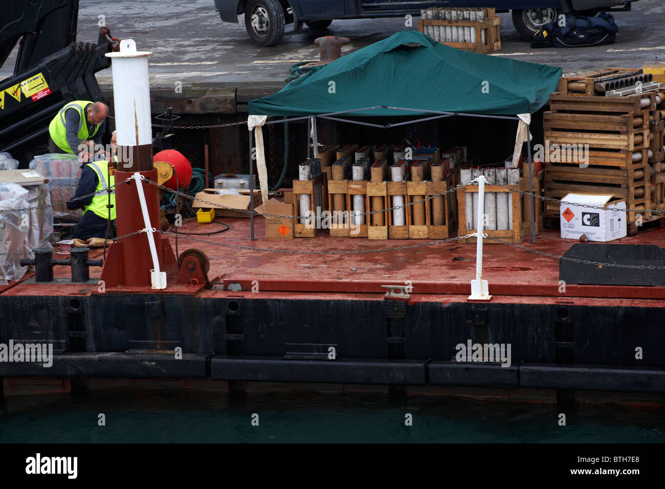 Preparing the fireworks on the platform in Poole Harbour ready for the Poole Quay fireworks display Stock Photo