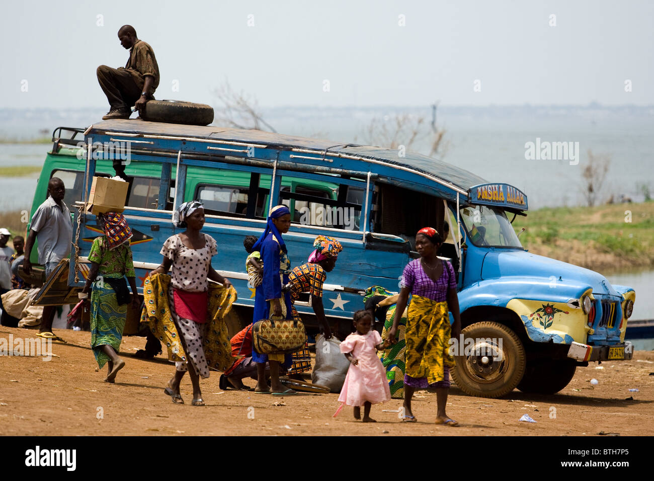 Local transportation awaits passengers at a ferry terminal on the shore of Lake Volta in Makango, northern Ghana Stock Photo