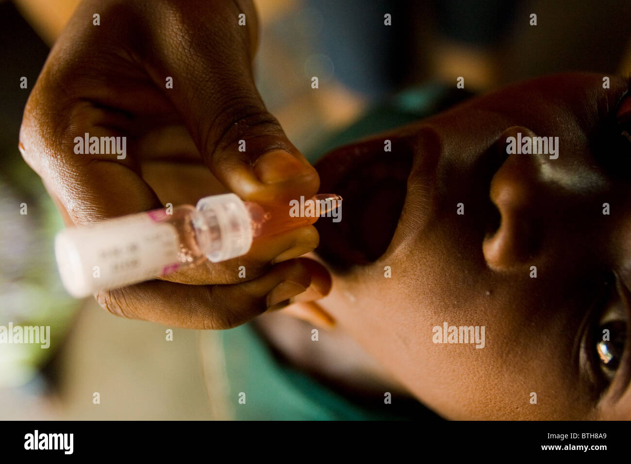 A health worker vaccinates a child during a national polio immunization exercise Stock Photo