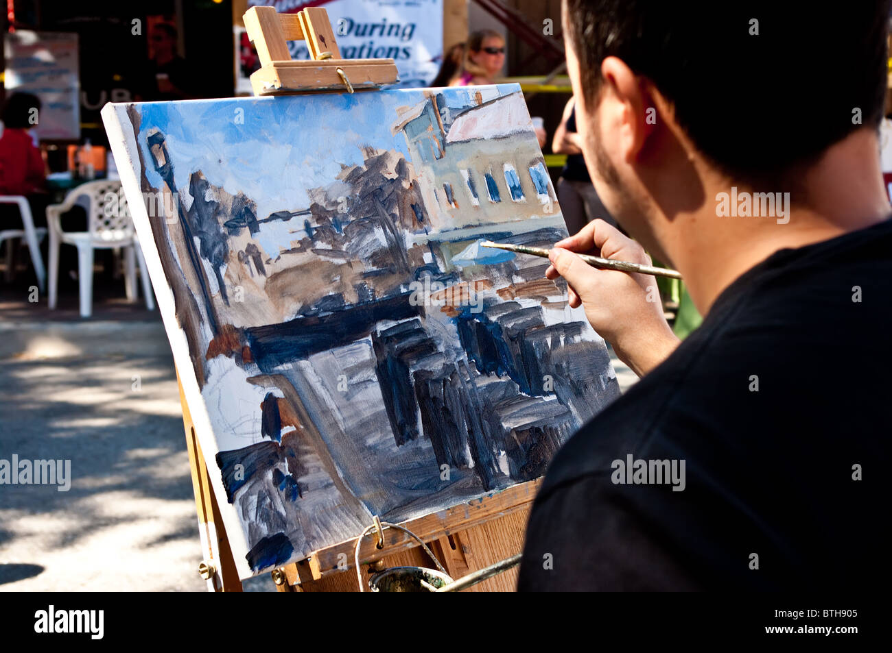 Street painter demonstrating his skills at art fair in Bradenton, Florida Stock Photo