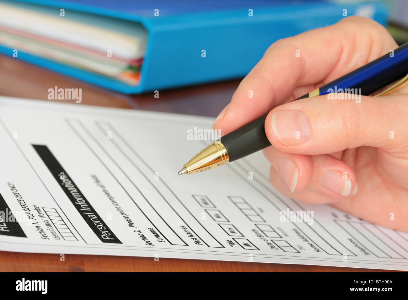 Hand with Pen Completing Personal Information on Form Stock Photo - Alamy