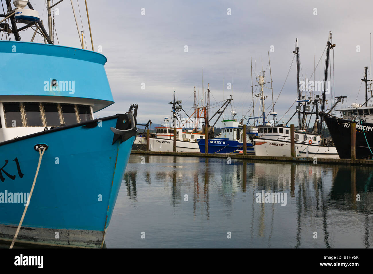 Colorful commercial fishing boats in marina on the Siuslaw River in