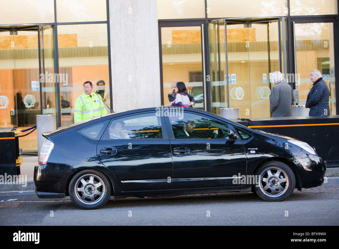 The irony of a Toyota Prius hybrid car parked outside Shell's UK headquarters in London. Stock Photo