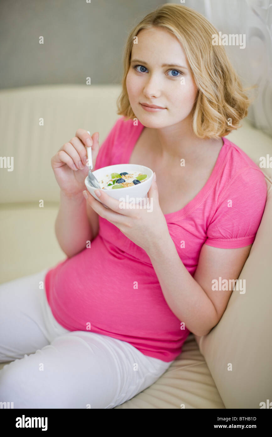 pregnant woman eating muesli Stock Photo Alamy