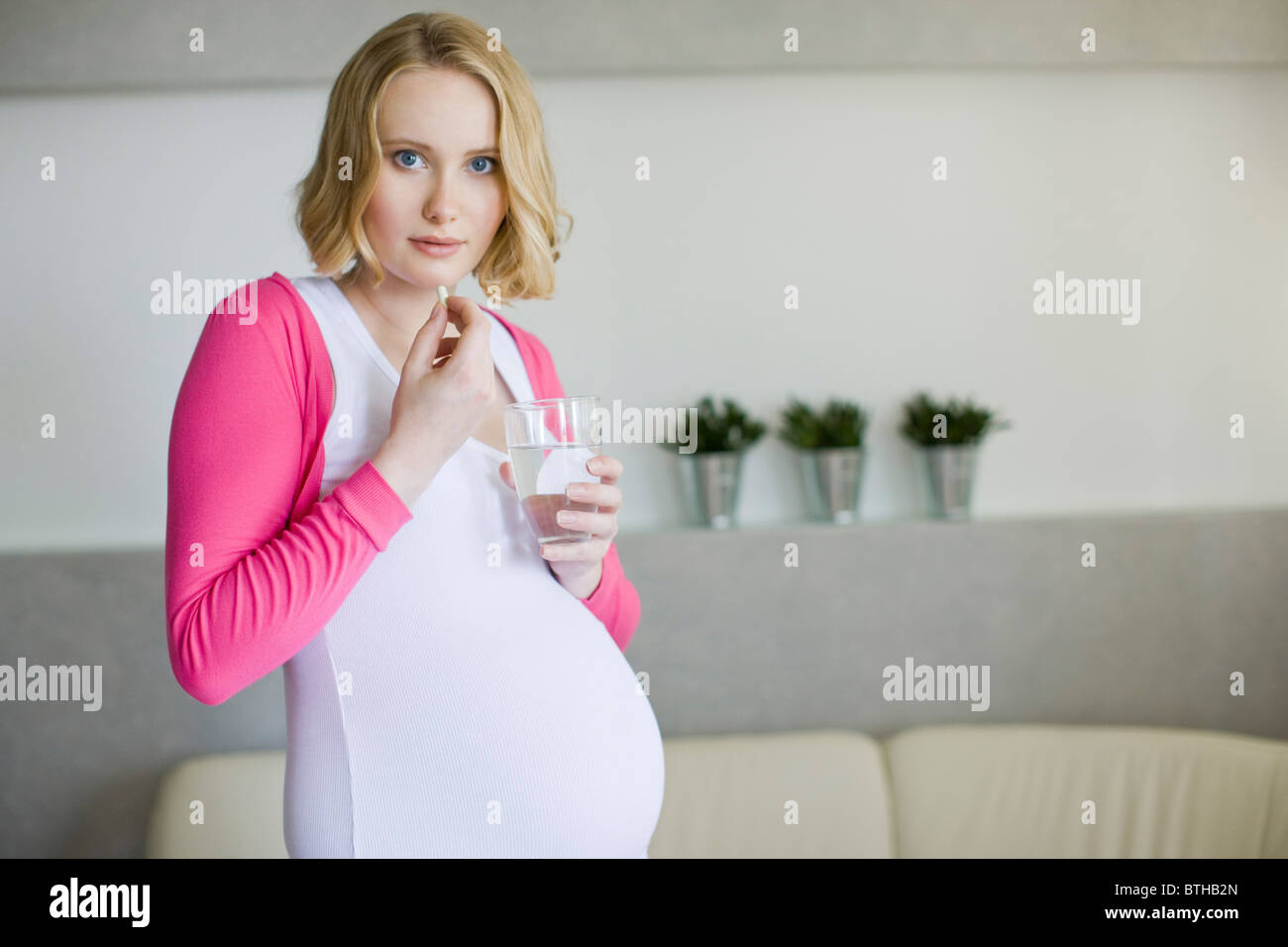 pregnant woman with medicines Stock Photo