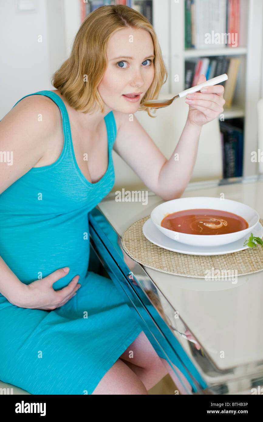 pregnant woman eating tomato soup Stock Photo Alamy