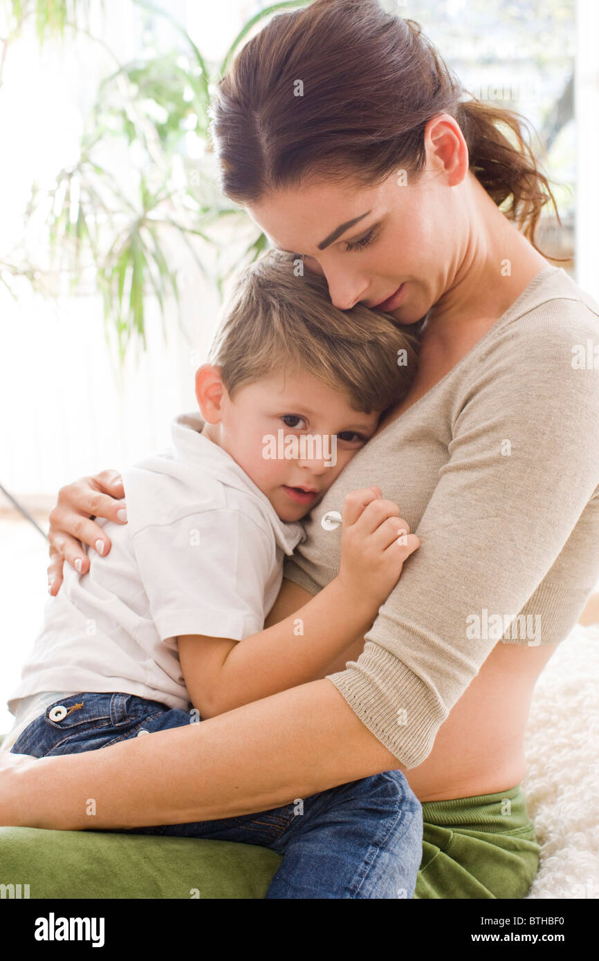 Mother hugging sad son Stock Photo - Alamy