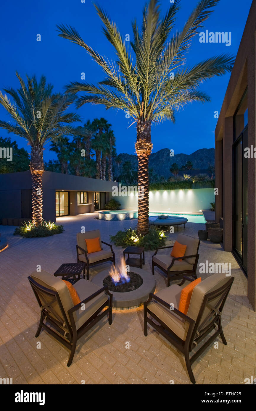 Lit Palm Trees At Firepit With Chairs On Terrace Of California