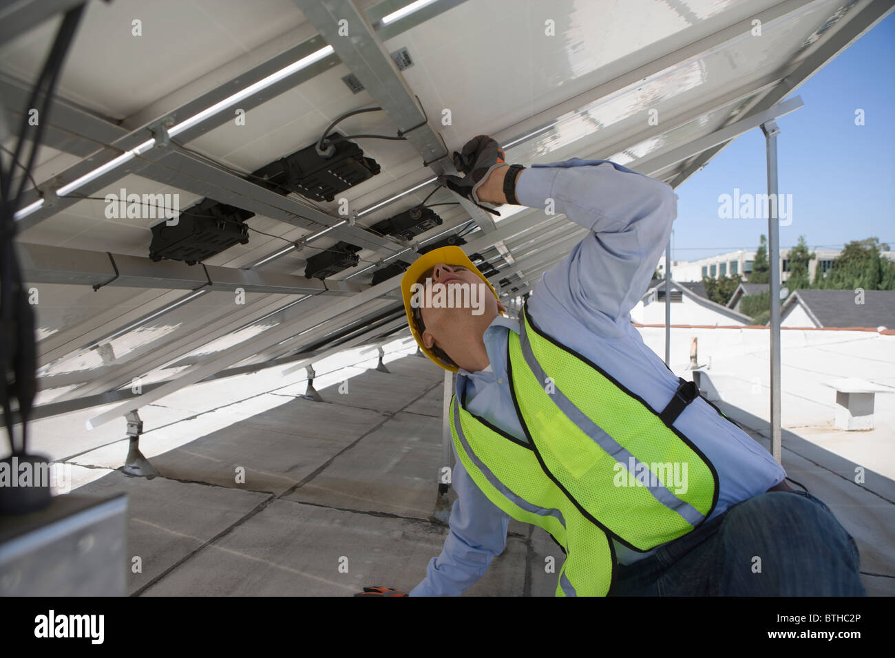 Maintenance worker adjusting solar panel in Los Angeles, California Stock Photo