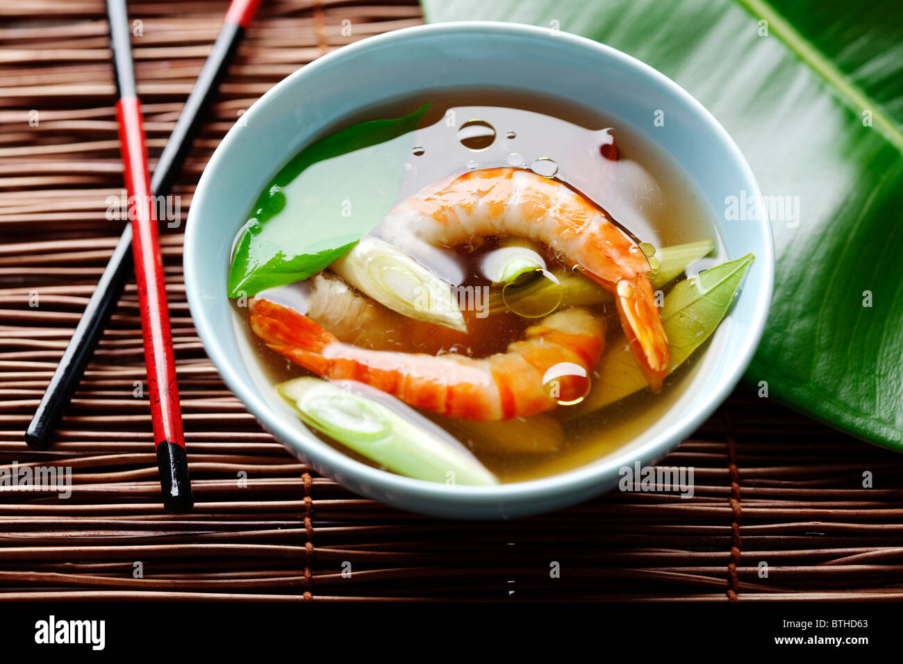 asian shrimp soup with kaffir leaves and spring onions Stock Photo