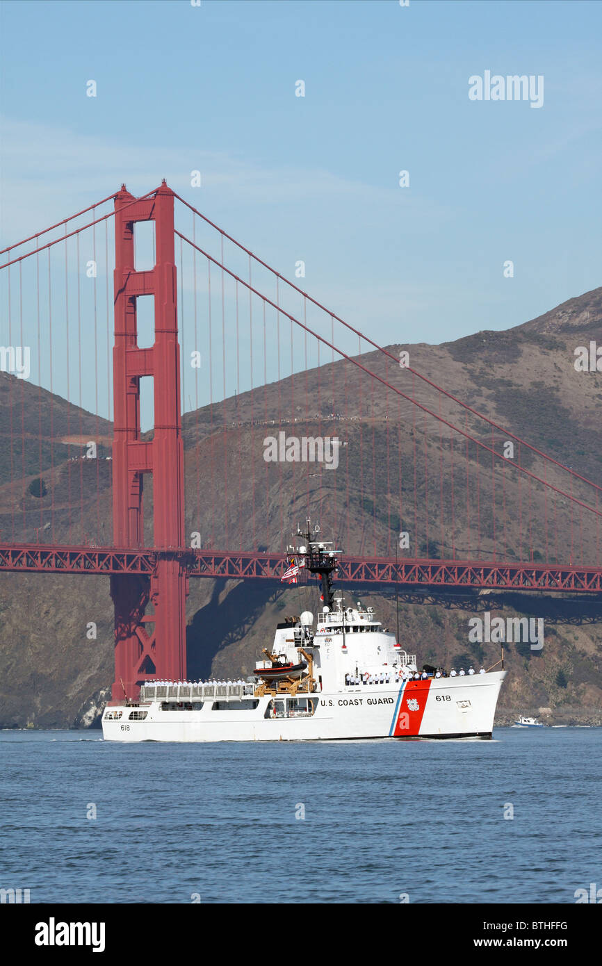 The United States Coast Guard Cutter Active (WMEC-618) travels across San Francisco Bay past the Golden Gate Bridge Stock Photo