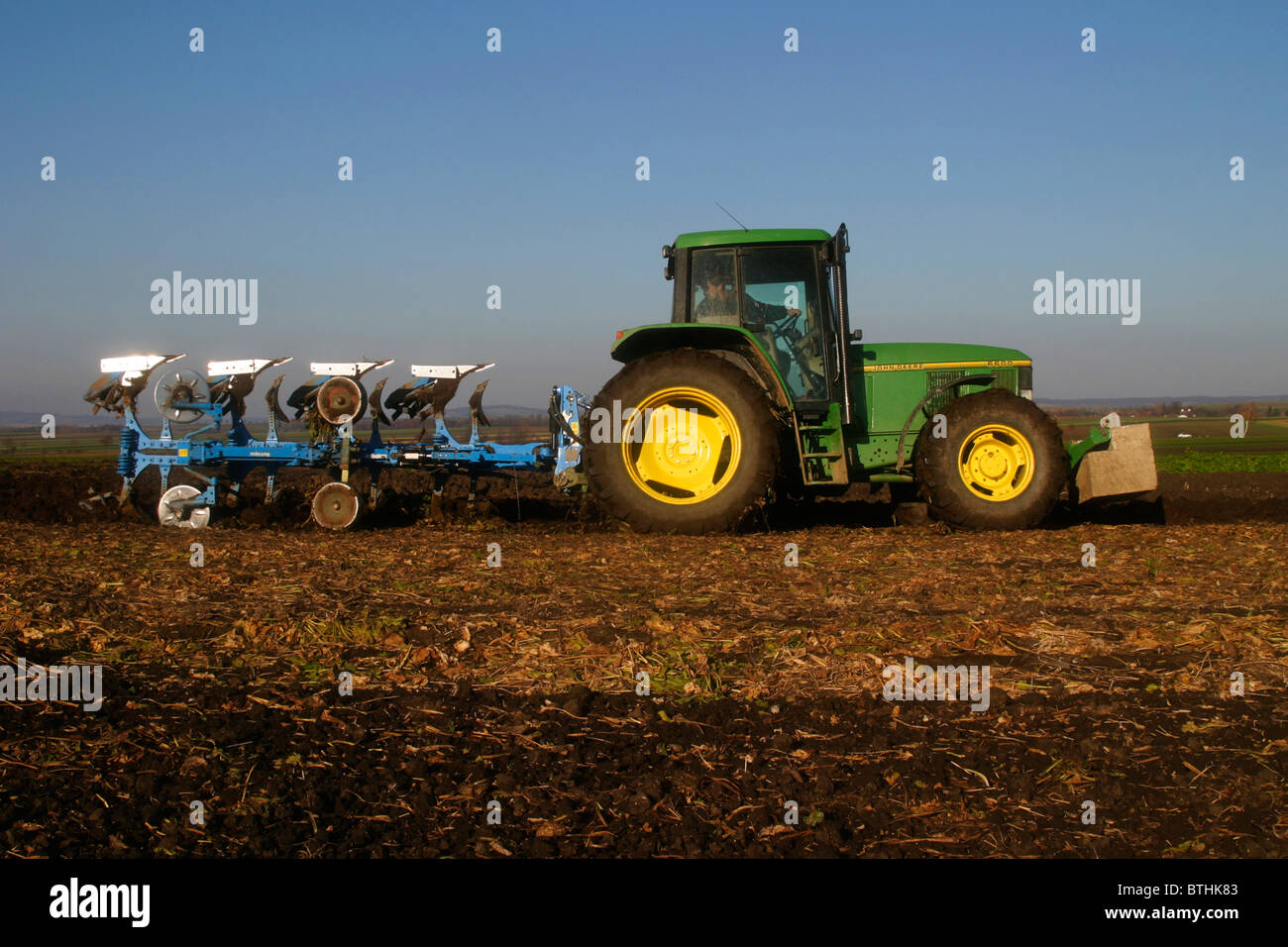 Tractor with plow Stock Photo - Alamy