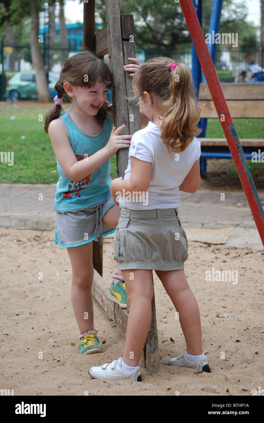 Two preschool girls of 5 playing in a playground Stock Photo - Alamy