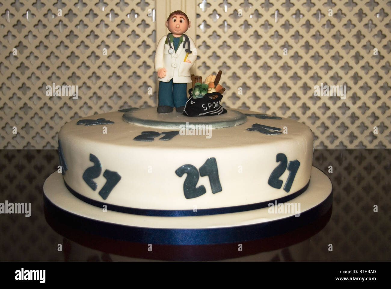 A 21st birthday cake portraying a sports enthusiastic doctor Stock Photo