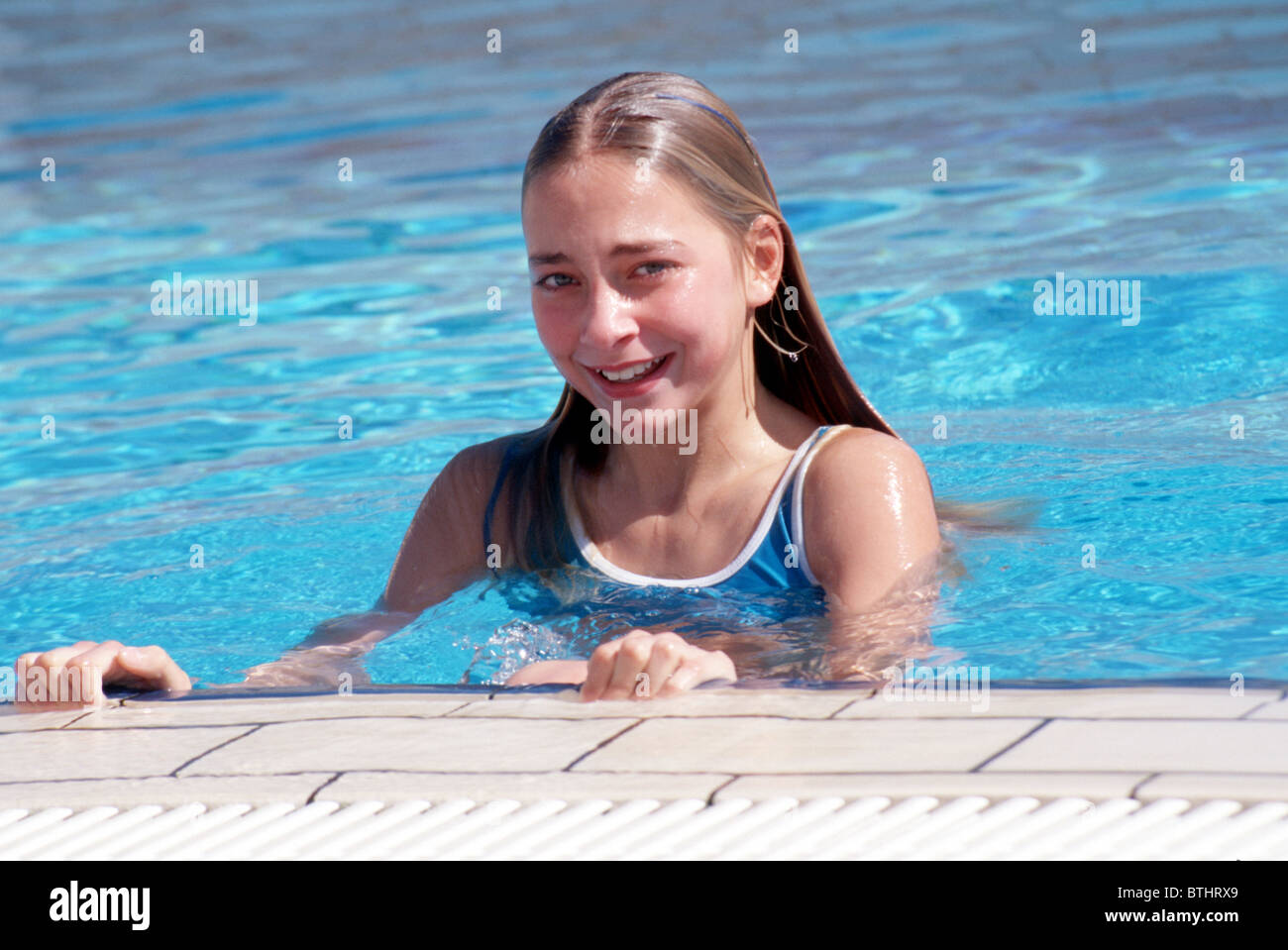 Preteen girl swimming pool Stock Photo