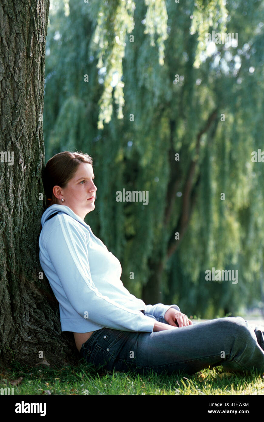 Young woman thinking profile Stock Photo - Alamy