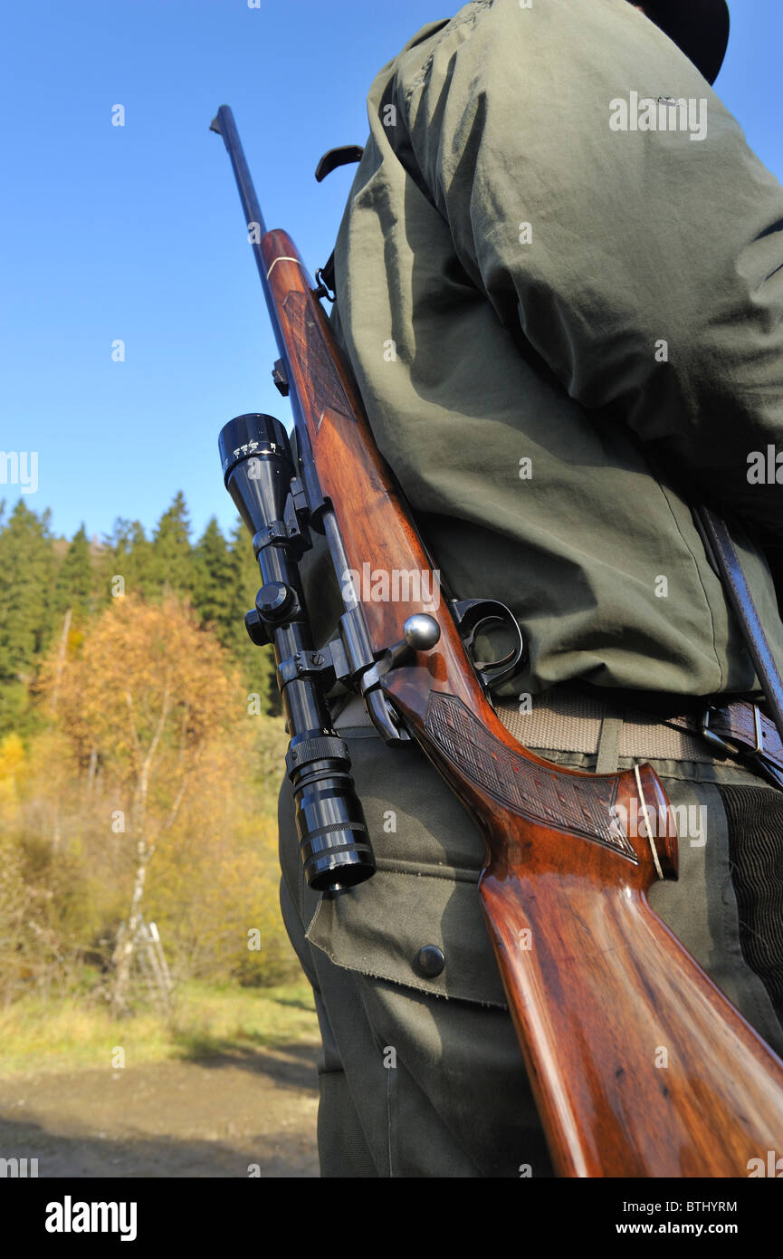 Hunter with shotgun and scope in the Ardennes, Belgium Stock Photo