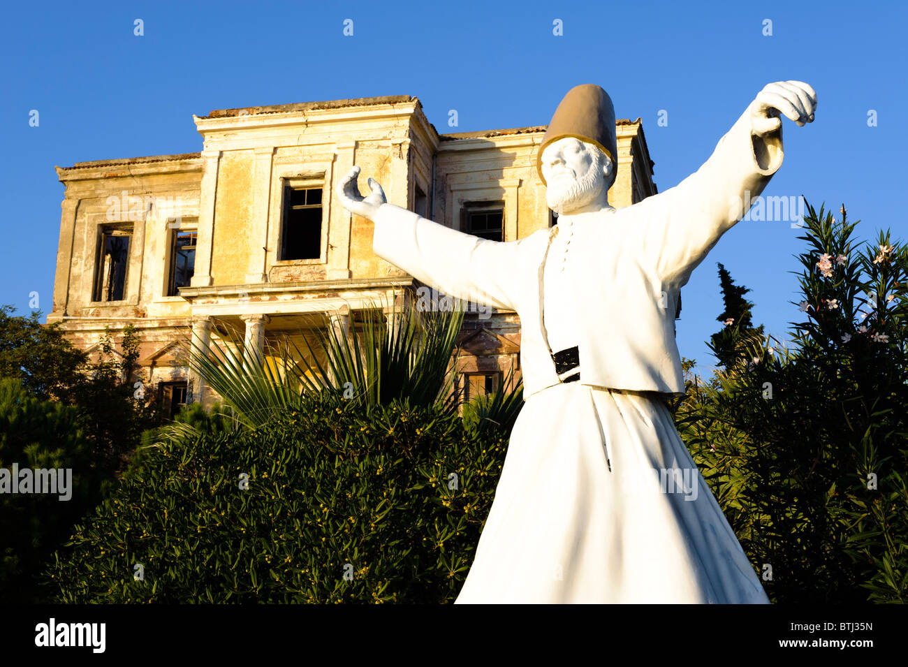 Greek house and Turkish statue, Cunda Island promenade. Stock Photo